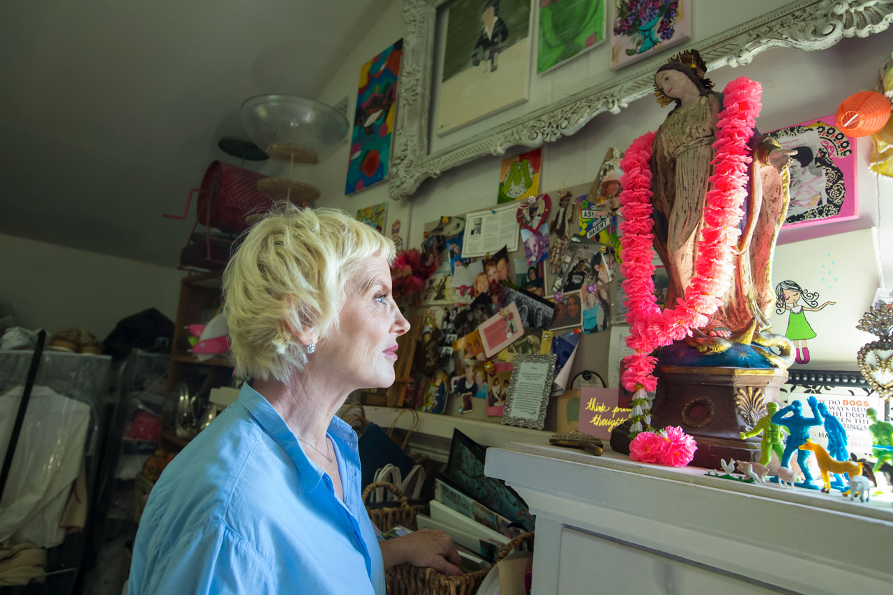 Donna Mcnutt looking at a collection of collages and kids' toys
