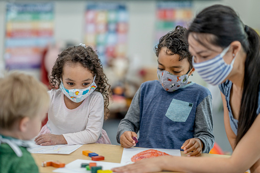 Group of children coloring at a table 