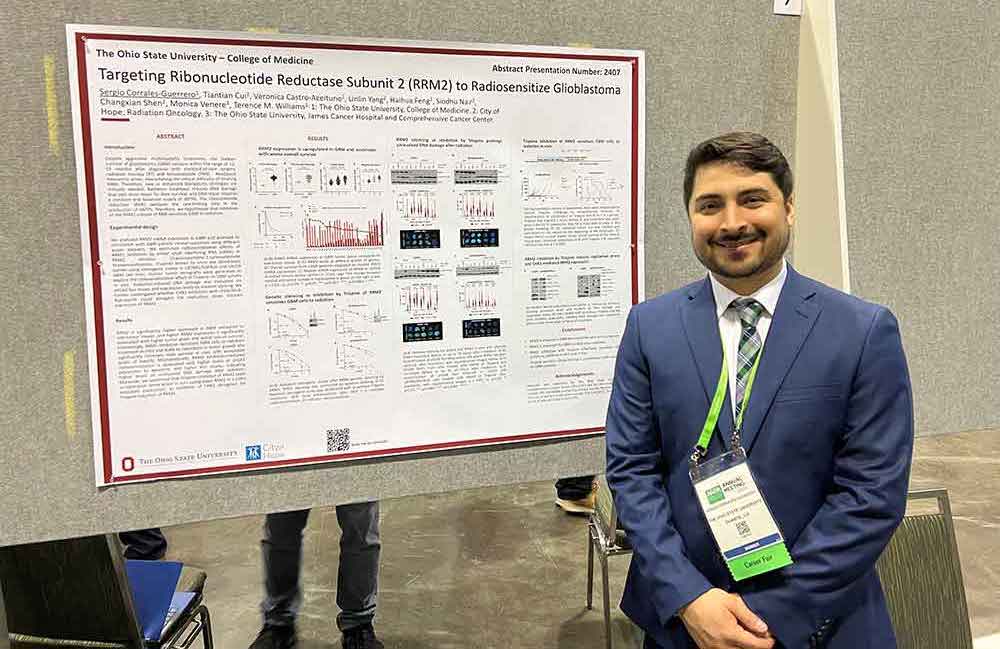 Sergio Corrales-Guerrero in front of presentation at the AACR 2023 Conference