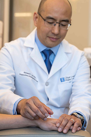 Richard T. Lee, M.D., performing acupuncture