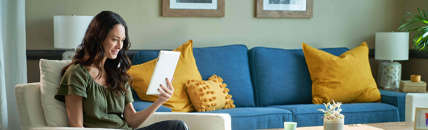 Adult patient holding a tablet and searching for health insurance information.