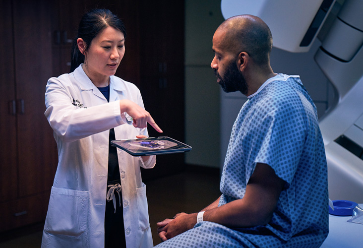 Physician talks to patient