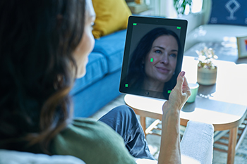 HomeOncology - woman sitting with her tablet