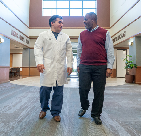 Physician talks to patient