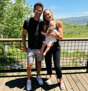 Husband and wife holding their daughter