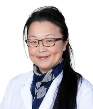 Female doctor headshot in white lab coat