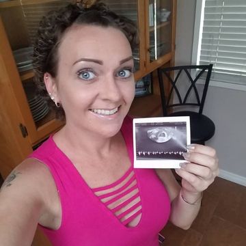 Jennifer Rancik holding baby ultrasound.