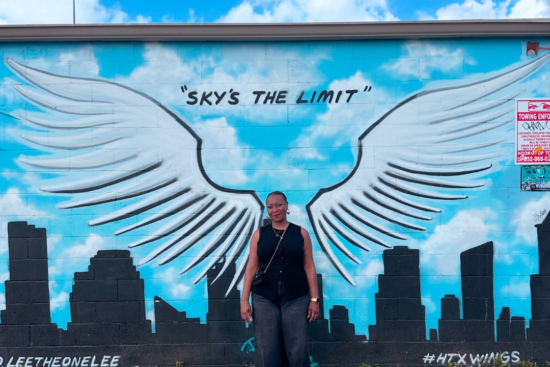 Amber Mike in front of mural