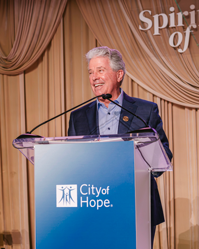 Dan Hedigan at podium speaking at CIA Spirit of Life event