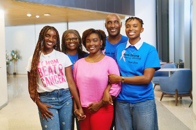 Patient Sade Wilson (in pink) credits family and close friends as her support network during and after breast cancer treatment. Here, she is surrounded by her daughter (far left), mother, father and youngest sister (far right). Photo: City of Hope.