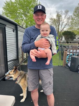 Les Balaszek and grandbaby posing for a picture