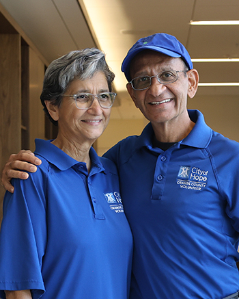 Parizad and grateful patient Seth in City of Hope Orange County volunteer shirts