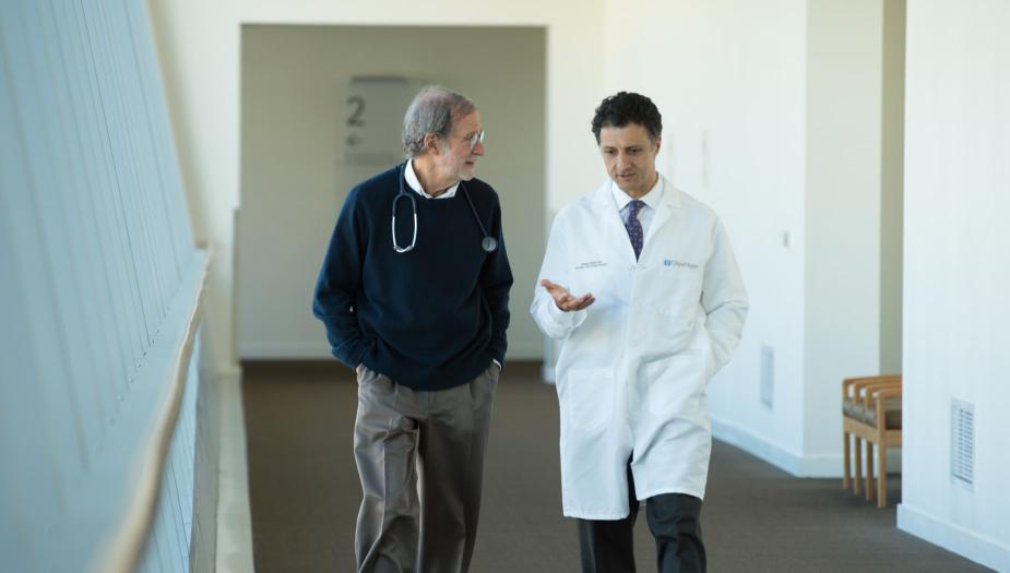 Two researchers walking down a hallway.