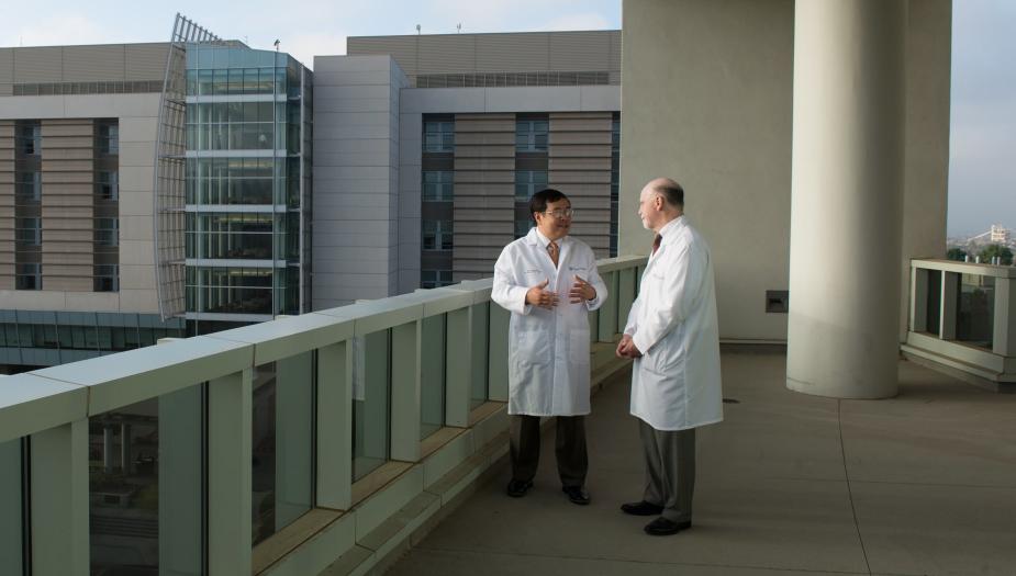 Two researchers standing exterior 