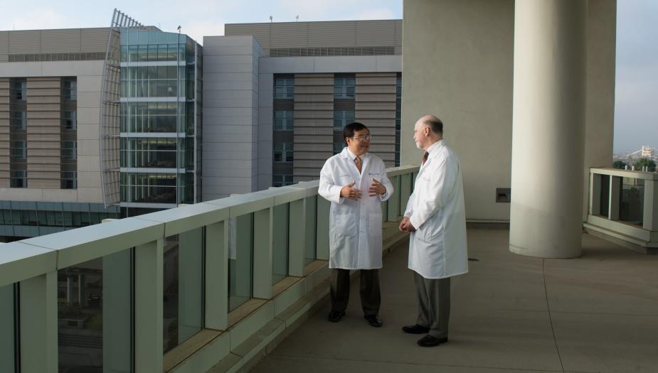 Two researchers standing exterior