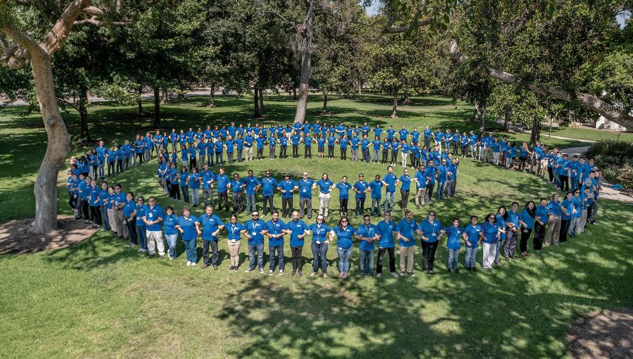 Many people standing in a spiral at an event
