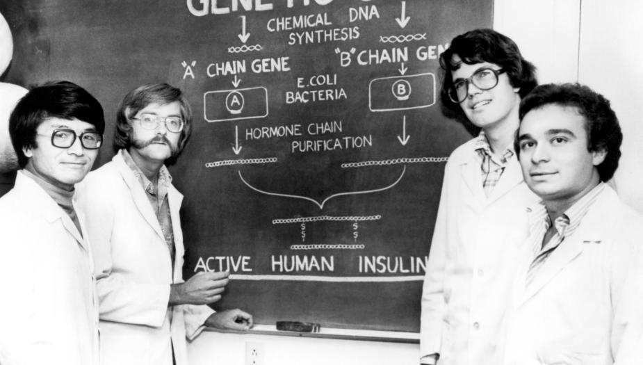 A historic photo of four researchers standing together
