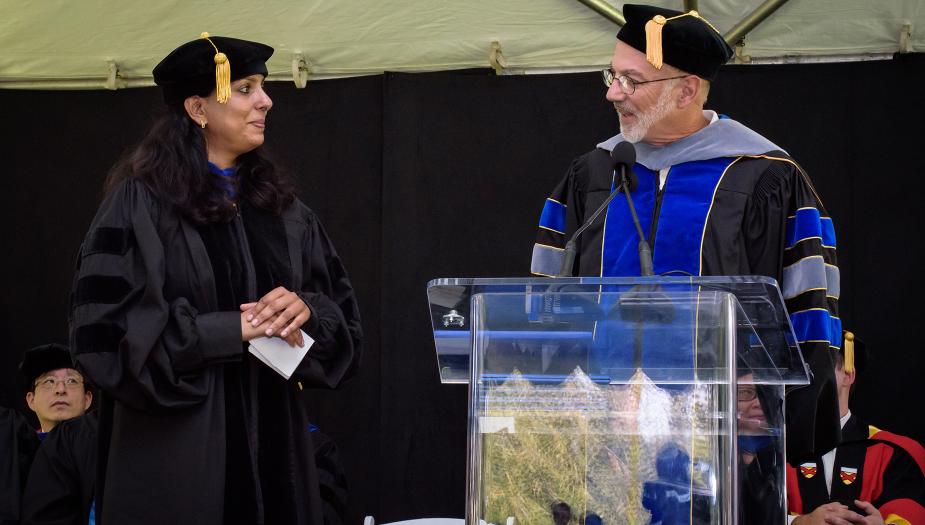 Two people at a graduation ceremony