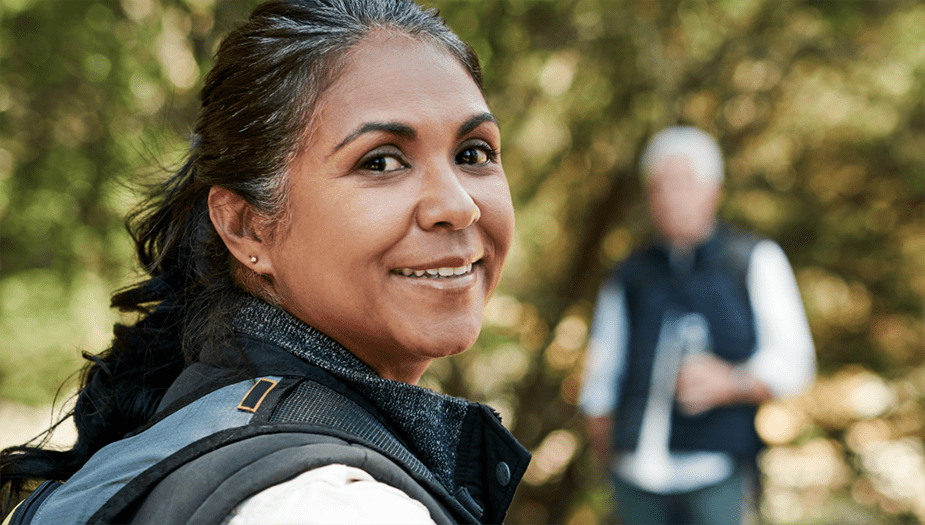 woman recovering from lung cancer standing against trees enjoying a day outdoors