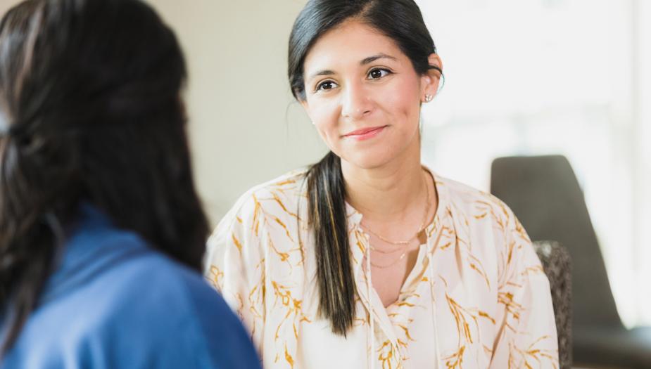 woman smiling in conversation with another woman