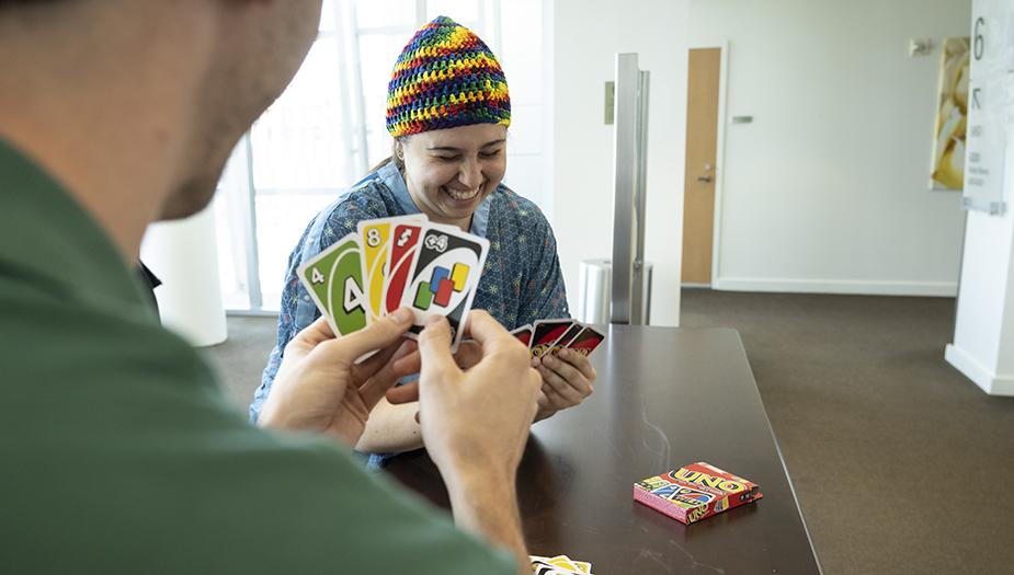 Patient smiling while playing a card game