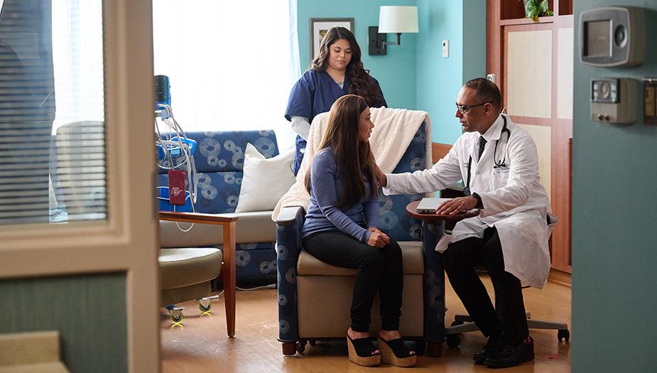 Doctor consulting patient in an exam room.