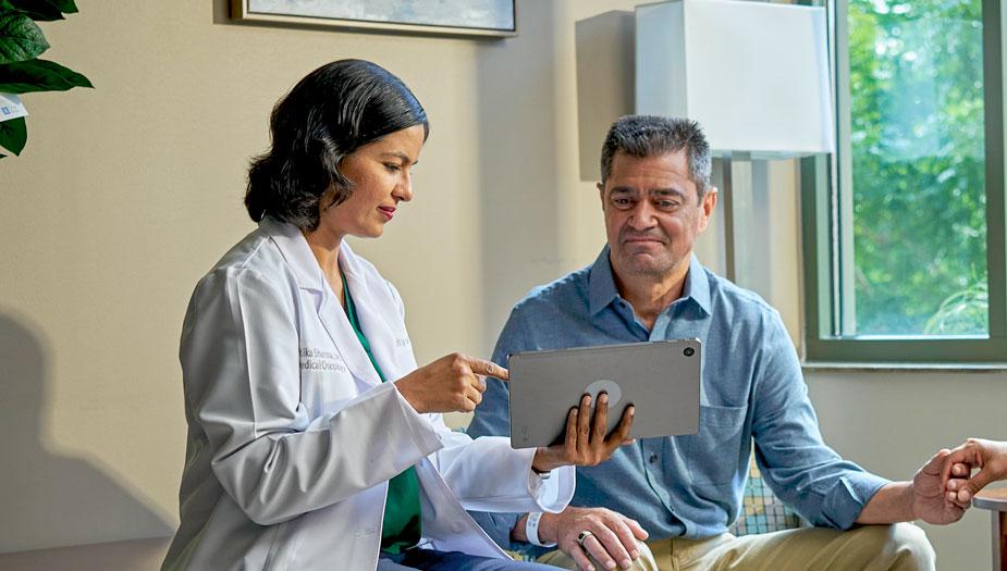 Physician explaining information to a patient using a tablet