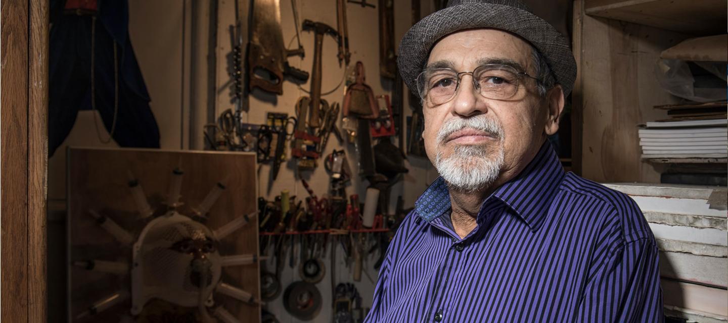 Joe Bravo Standing Amid Art