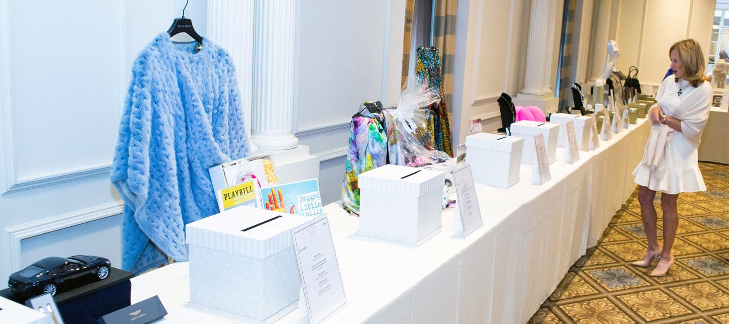 Award luncheon silent auction table with blue dress
