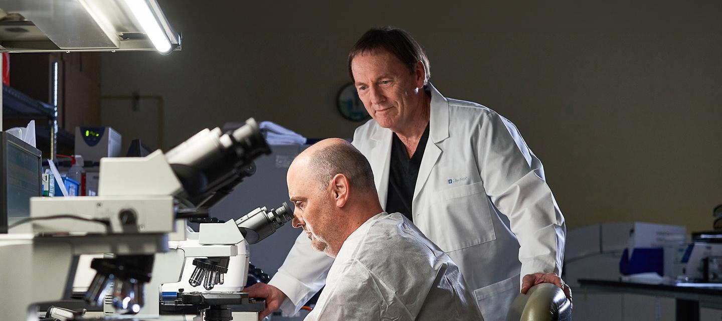 Phoenix researcher looking through microscope