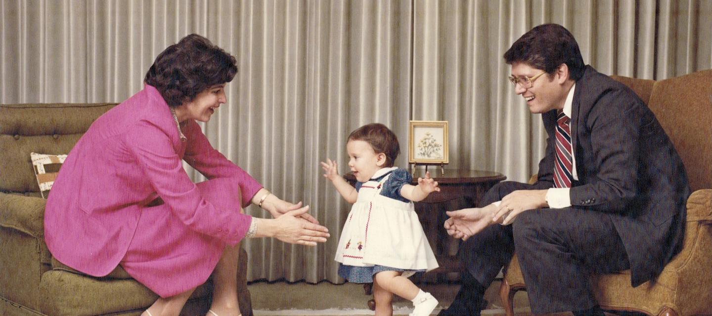 Family photo of Emmet and Toni Stephenson with their daughter, Tessa, in their family living room.