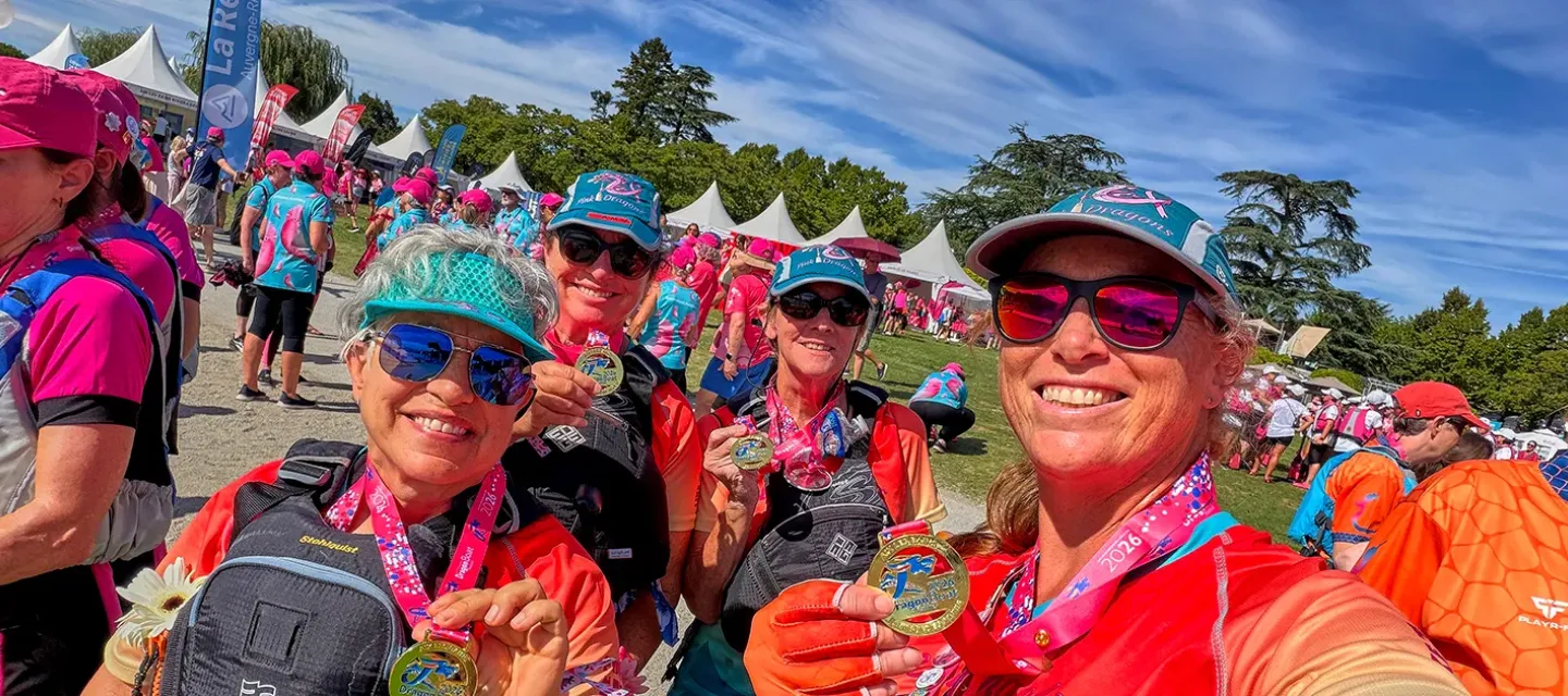 Caroline de Vaulx and Pink Dragons team members with medals at a dragon boat event