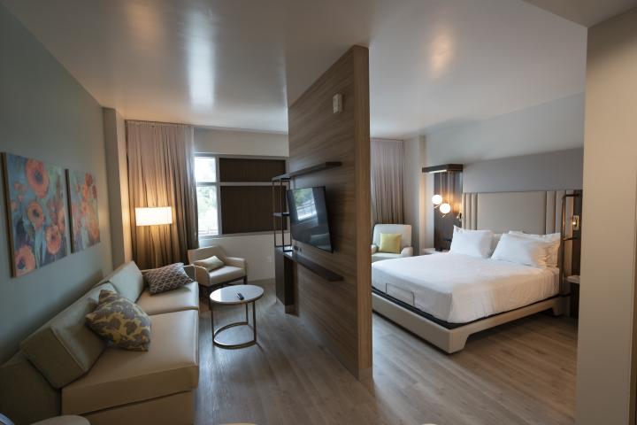 Hope Village Hotel studio room features a divider panel between the lounging space and the bed area