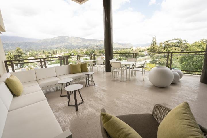Hope Village hotel has a covered patio with comfortable seating options and a nice view.
