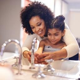 Mother and daughter washing hands