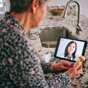 Woman using telehealth services Woman using telehealth services