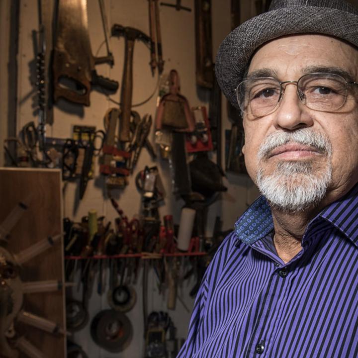 Joe Bravo Standing Amid Art