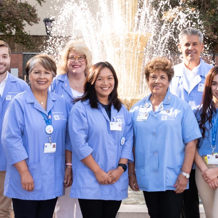 Group of volunteers standing near fountain