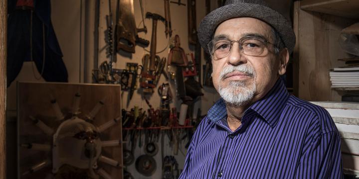 Joe Bravo Standing Amid Art