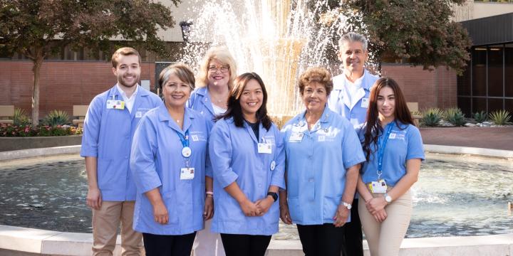 Group of volunteers standing near fountain