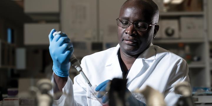Doctor Ogembo working in lab