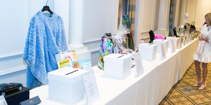 Award luncheon silent auction table with blue dress