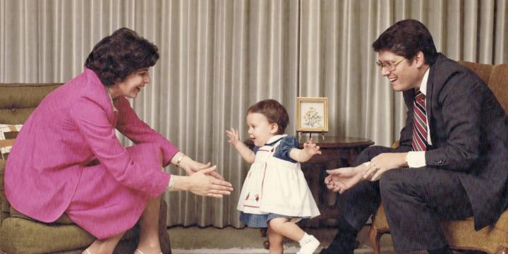 Family photo of Emmet and Toni Stephenson with their daughter, Tessa, in their family living room.