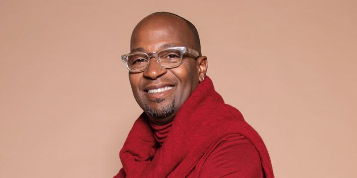 songwriter and vocal producer Kuk Harrell smiling joyfully