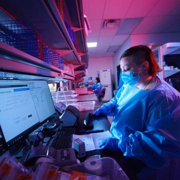 Researchers with masks working inside the Translational Genomics Research Institute lab