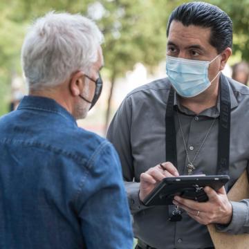 Two person talking and taking notes on a pad