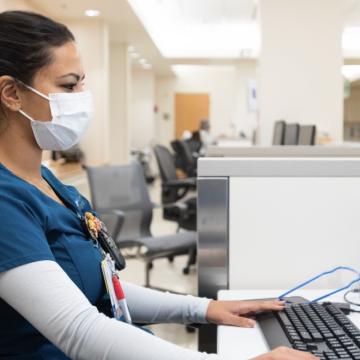 A healthcare worker sitting at a desk