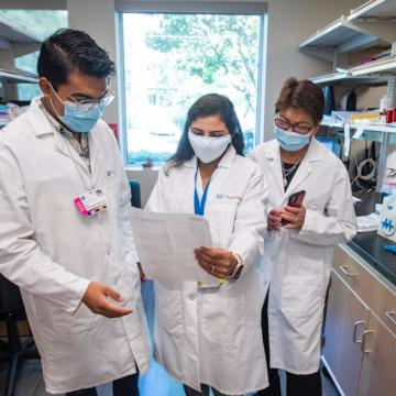 three researchers in a lab