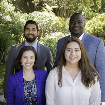 four young adults posing for picture