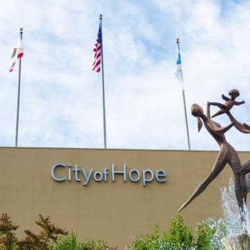 Campus view with the Spirit of Life fountain, depicting two parents lifting a child with joy